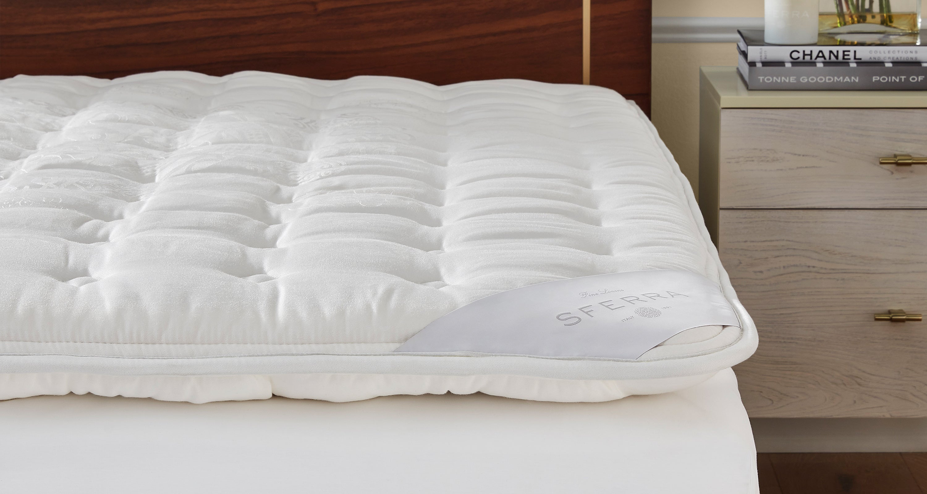 A SFERRA Mattress Pad on top of a mattress.