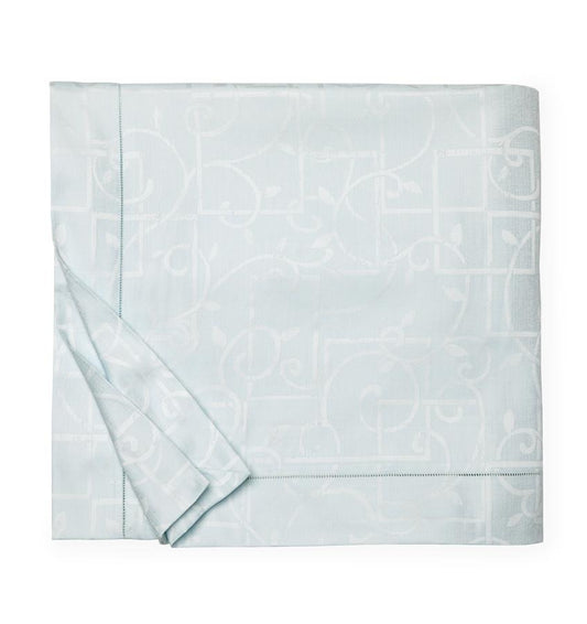 A SFERRA Graticcio Duvet Cover in pale blue folded into a square against a white background.