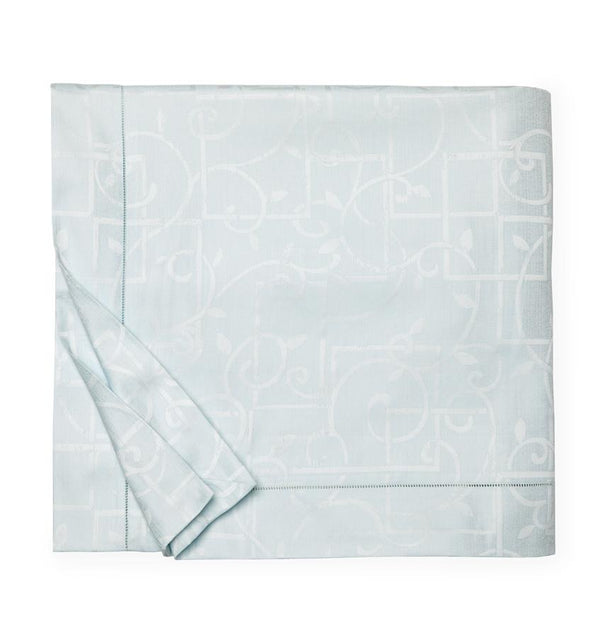 A SFERRA Graticcio Duvet Cover in pale blue folded into a square against a white background.