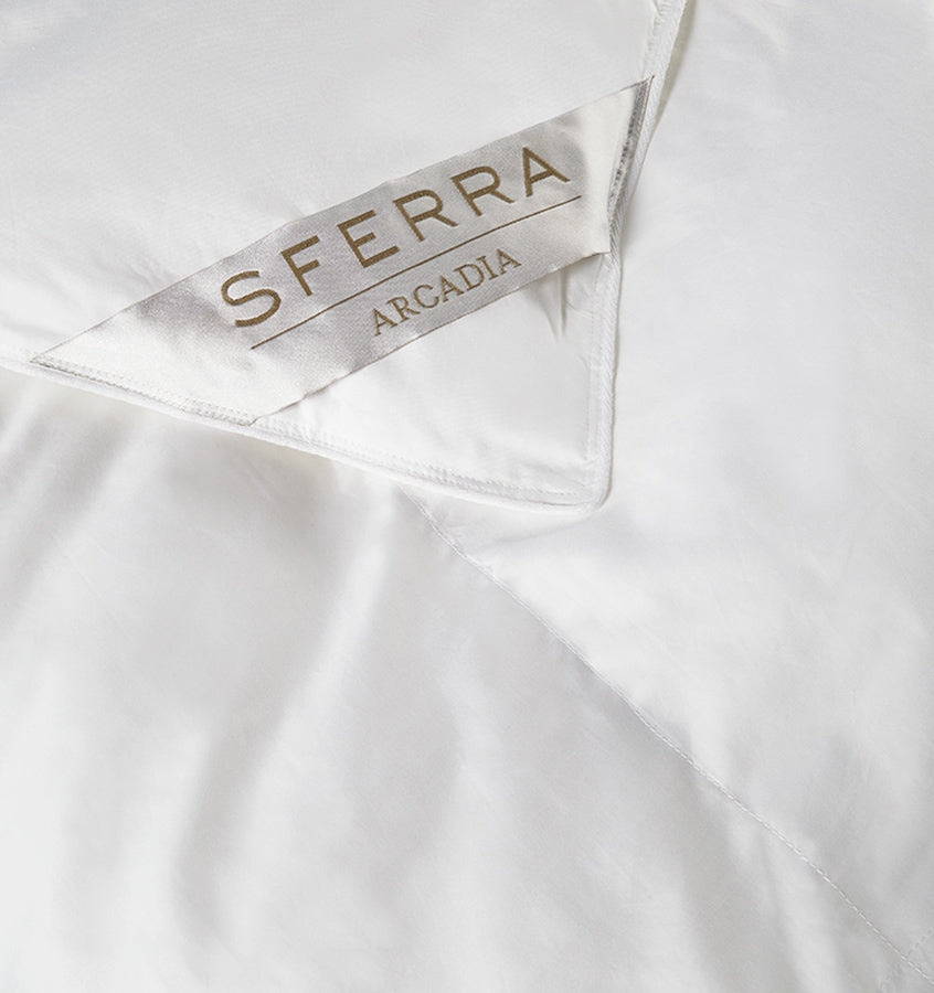 A hypoallergenic microfiber fills SFERRA's Arcadia down alternative duvet.