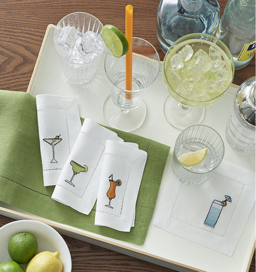 SFERRA Bevande cocktail napkins feature a Martini, Margarita, Orange Crush and Blue Hawaiian on hemstitched linen napkins.