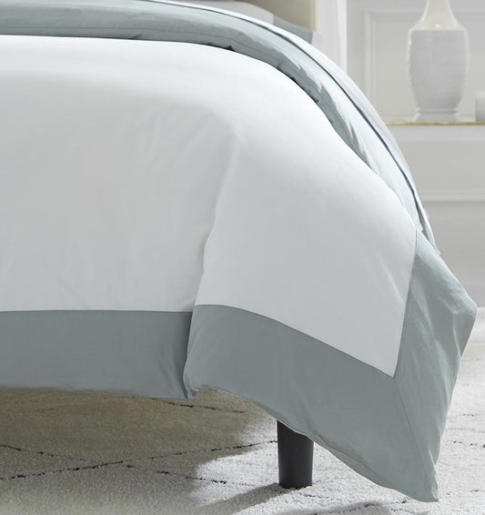 Casida Duvet Cover is minimal with its contrast color border in sateen appliqué along one side, and solid sateen on the reverse.