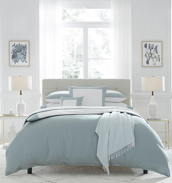 Casida Duvet Cover is minimal with its contrast color border in sateen appliqué along one side, and solid sateen on the reverse.