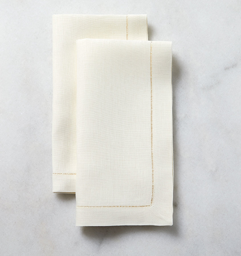 The SFERRA Classico napkin is our finest linen, woven with a border of delicate, refined hemstitching. Each thread is drawn by hand creating heirloom table linens to last for generations.