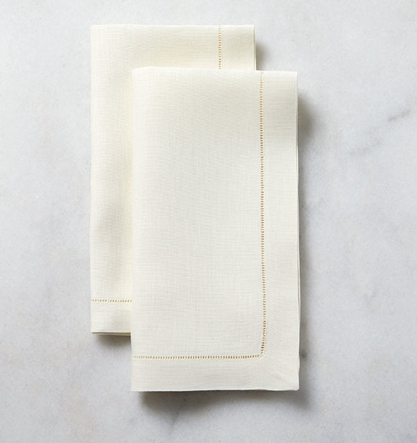 The SFERRA Classico napkin is our finest linen, woven with a border of delicate, refined hemstitching. Each thread is drawn by hand creating heirloom table linens to last for generations.