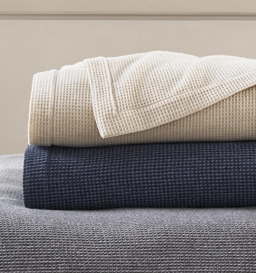 The SFERRA Talida Blanket, a traditional waffle weave with two tonal shades. It is woven with the finest Merino wool.