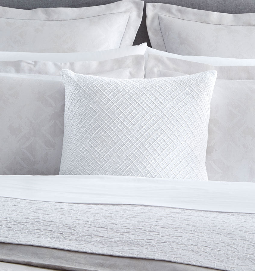 A classic diamond pattern reimagined, Traliccio's layered dual-tone embroidery lends delicacy and depth to any room.